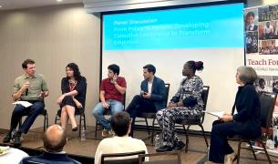 SIx people in chairs in front of a screen. 