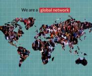 A young woman with shoulder-length brown curly hair and pale skin wearing a red shirt speaks while seated as others at the table watch and listen