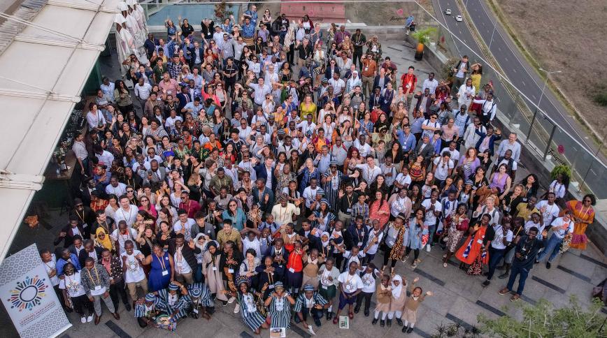 An overhead shot of a large, diverse group of people on a roof 