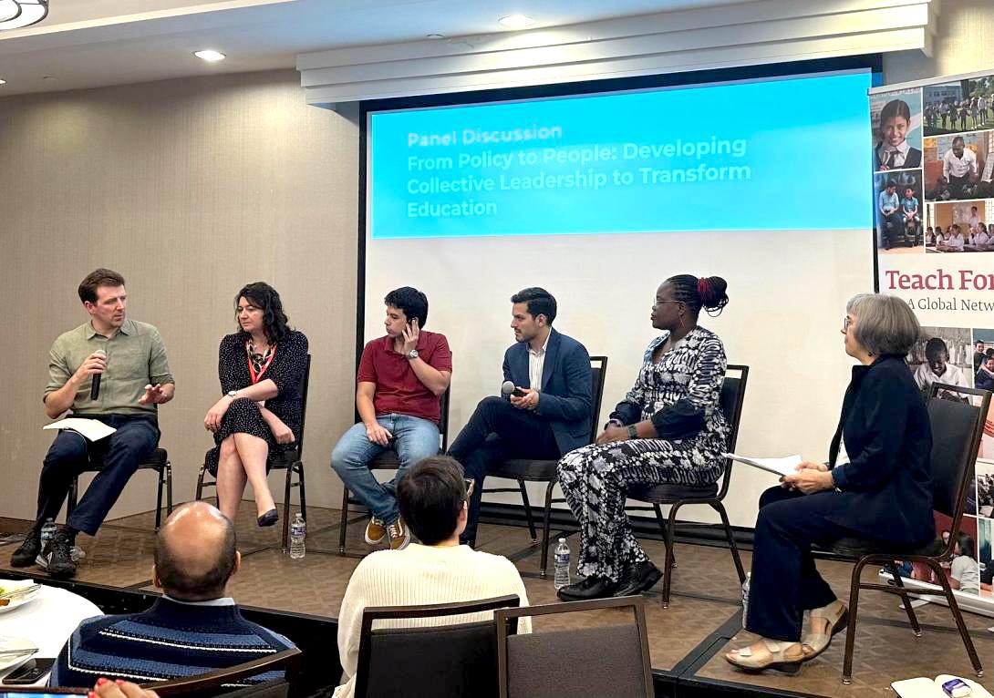 SIx people in chairs in front of a screen. 